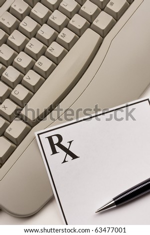 Blank prescription with a pen laying on computer keyboard.  Concept of online prescription,medical or healthcare.