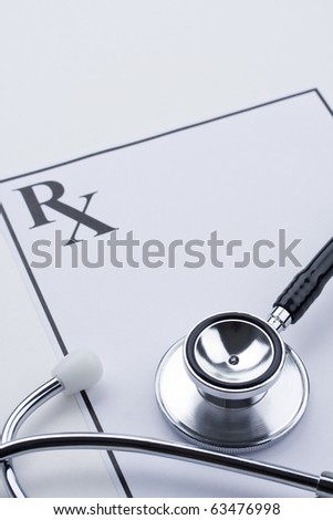 Doctor\'s stethoscope sitting on blank prescription. Concept of medical or healthcare.