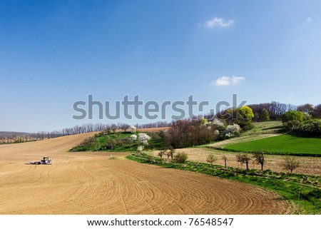 Spring farmland - tractor on the field