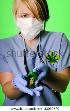 Image of a healthcare professional wearing surgical scrubs, stethoscope and mask holding a prescription bottle with marijuana inside on a chroma key background