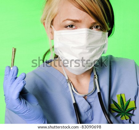 Image of a healthcare professional wearing surgical scrubs, stethoscope and mask presenting a marijuana joint on a chroma key background