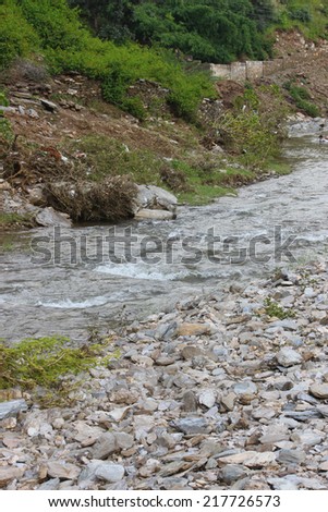 stream with transparent water and stones on bottom