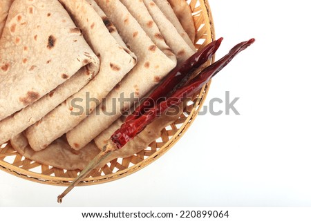 Roti Paratha isolated on white. Indian Bread in wooden Basket
