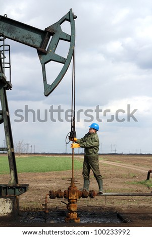 oil worker standing at pipeline