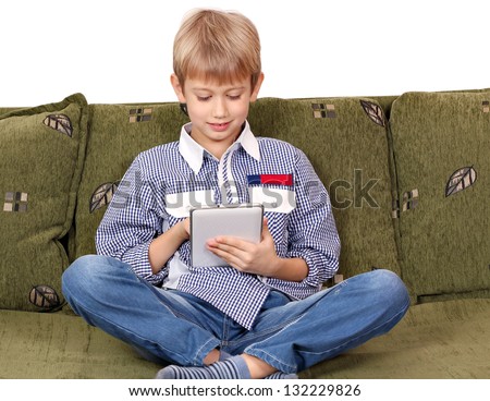 boy sitting on bed and play with tablet pc