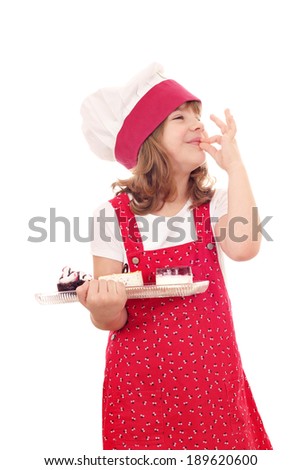 little girl cook with sweet cakes and ok hand sign