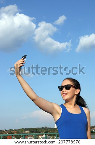 beautiful girl make selfie on a smart phone