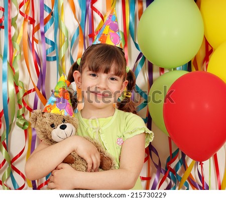 happy little girl with teddy bear birthday party