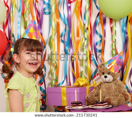 happy little girl with gift cakes and teddy bear birthday party