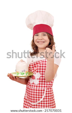 happy little girl cook with cake and thumb up