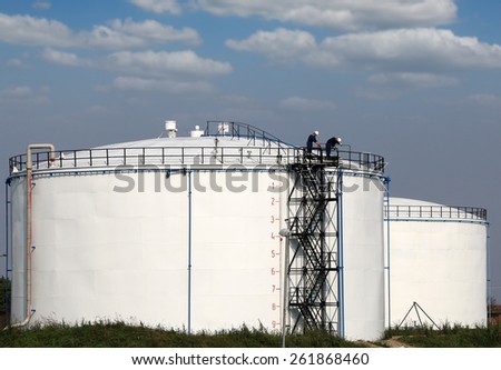 workers on oil tank industry zone
