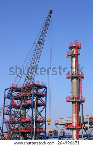 new refinery construction site with crane