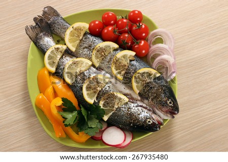 prepared fish with lemon and vegetables