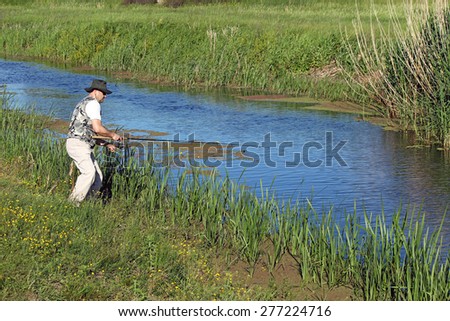 fisherman flying fishing on river
