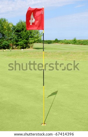 green golf field with red flag