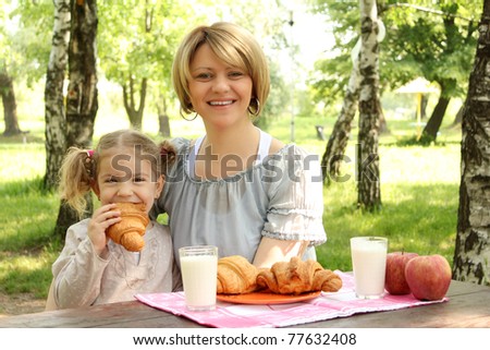 mother and daughter breakfast in nature