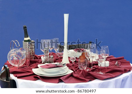 table with glasses and dinner service