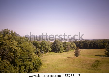 Toned image of Hudson Valley view with the Hudson River behind the trees.