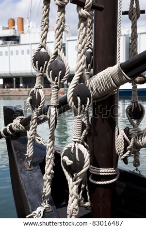 Pulley block on an old wooden sail boat with ropes