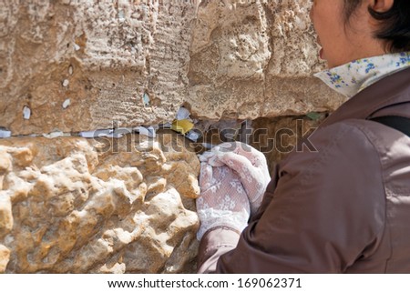 JERUSALEM, ISRAEL-MARCH 14, 2006:A woman prays at the Wailing Wall. The Western Wall, Wailing Wall or Kotel is located in the Old City of Jerusalem at the foot of the western side of the Temple Mount.