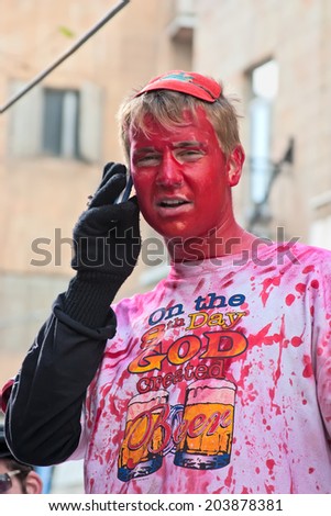 JERUSALEM, ISRAEL - MARCH 15: Portrait of a young man his face is painted in red. Purim is a Jewish holiday. Purim is the custom of masquerading  in costume and the wearing of masks.