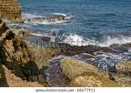 Wave and sea foam on the shore of the Mediterranean Sea.