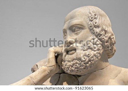 Ancient ruins of the Philippeion at Olympia, Greece. Detail of an ancient Greek statue of a human. Site of the ancient Olympic Games is situated on the Peloponnese. UNESCO world heritage site.