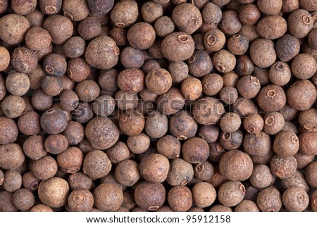 Allspice (jamaica pepper) berries texture, background full frame. Used as a spice in cuisines all over the world. The plant is also used in medicine.