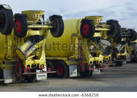 row of yellow cement trucks