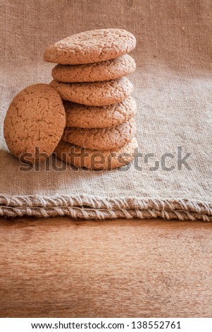 Freshly baked home made cookies on the sacking background / Stacked brown Cookies on rustic background