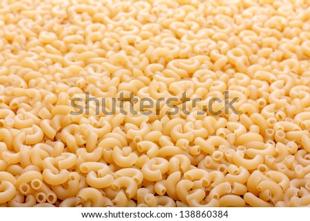 Italian pasta close up. Food background texture of the yellow pasta.