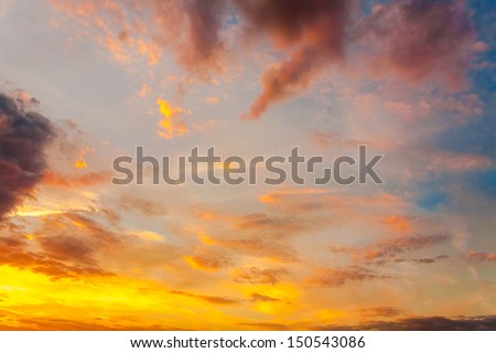 Bright Blue, Orange And Yellow Colors Sunset Sky. Sunlight through clouds
