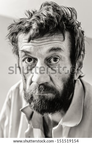 Serious sad old adult man with beard in black and white colors