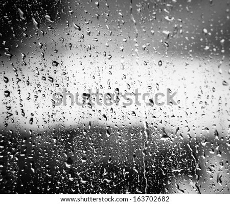 Water Drops Of Rain On Glass On Background Of Cloudy Sky