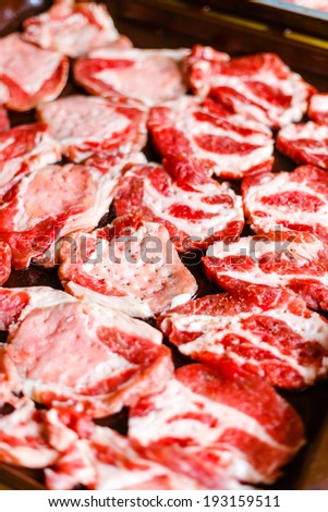 Pieces of fresh raw meat in a frying pan. Cooking meat for roasting baking