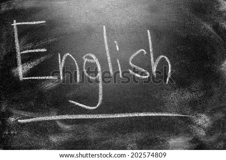 Learning language - English. Blackboard education concept.  Handwritten message on a school chalkboard writing English