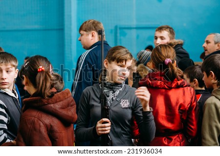 GOMEL, BELARUS - JANUARY 1, 2011: Unrecognizable Belarusian secondary school pupils girl shooting an air rifle at a school sports competition \
