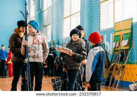 GOMEL, BELARUS - JANUARY 1, 2011: Unrecognizable Belarusian secondary school pupils preparing for school winter ski competitions \