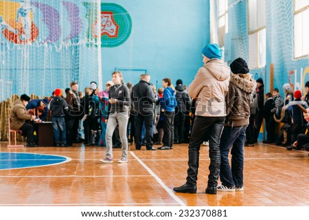 GOMEL, BELARUS - JANUARY 1, 2011: Unrecognizable Belarusian secondary school pupils girls watching school competitions \