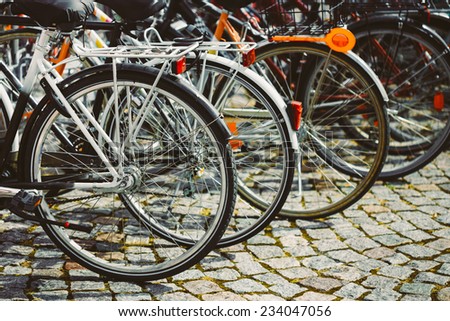 Parked Bicycles On Sidewalk. Bike Bicycle Parking In Big City. Toned Instant Photo