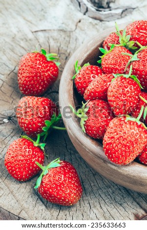 Strawberries. Organic Berries Closeup. Ripe Strawberry In The Fruit Garden, Old Wooden Bowl Filled With Succulent Juicy Fresh Ripe Red Strawberries On An Old Birch Stump. Toned Image
