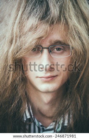 Portrait Of Rock Star Young Man Guy With Glasses And Long Hair Smiling And Looking At Camera