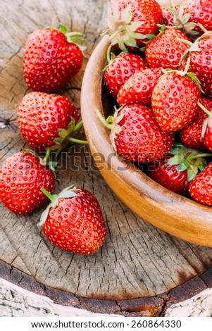Strawberries. Organic Berries Closeup. Ripe Strawberry In The Fruit Garden, Old Wooden Bowl Filled With Succulent Juicy Fresh Ripe Red Strawberries On An Old Birch Stump. Toned Instant Image