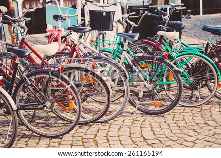 Parked Bicycles On Sidewalk. Bike Bicycle Parking In Big City. Toned Instant Filtered Photo