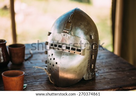Iron Helmet Of The Medieval Knight. Helmet Of A Medieval Suit Of Armour On Table