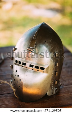Iron Helmet Of The Medieval Knight. Helmet Of A Medieval Suit Of Armour On Table
