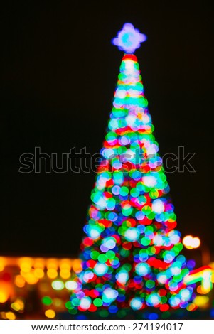 Defocused Blue Bokeh Background Effect. Design Backdrop. New Year Boke Lights Xmas Christmas Tree And Festive Illumination