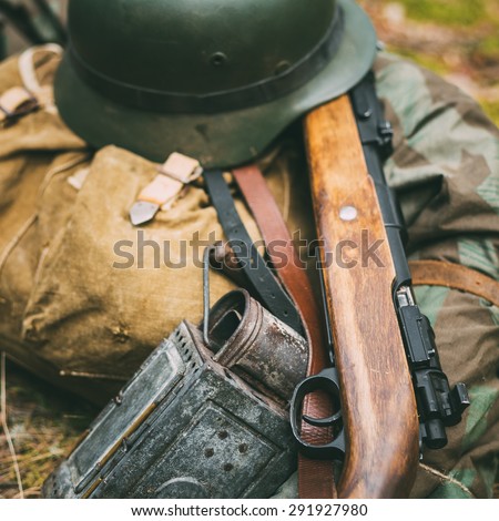 German military ammunition of World War II on ground. Military helmet, lights, rifle Mauser Karabiner 98k