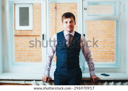 Handsome Caucasian Man In Business Attire Staying In Room Near Window