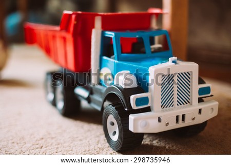 Colorful plastic toy truck on floor home